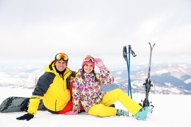 Photo of Lovely couple with equipment at ski resort. Winter vacation