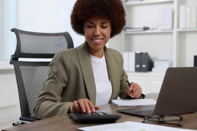 Photo of Professional accountant working at wooden desk in office