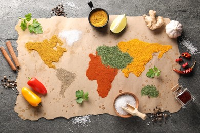 World map of different spices and products on grey table, top view