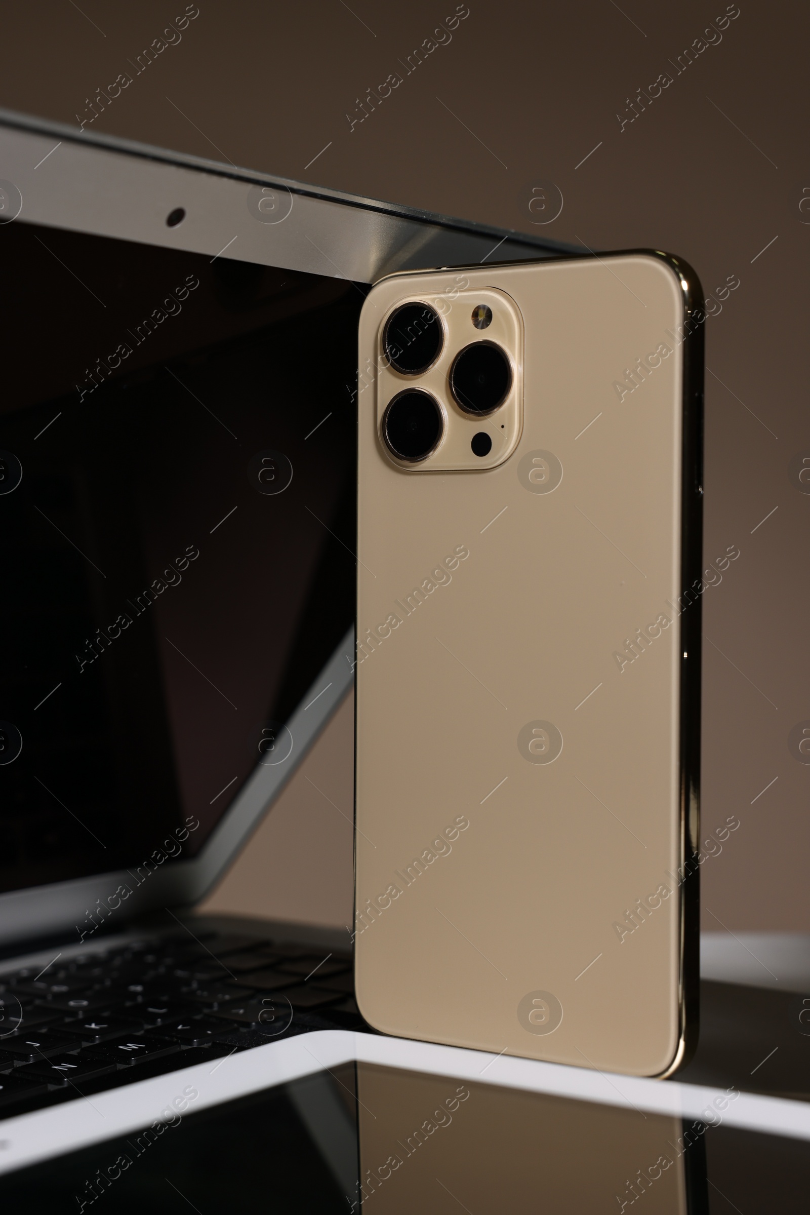 Photo of Many different modern gadgets on brown background, closeup