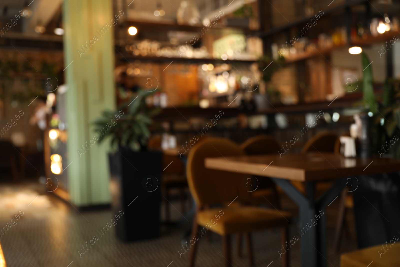 Photo of Blurred view of stylish modern cafe interior with bokeh effect