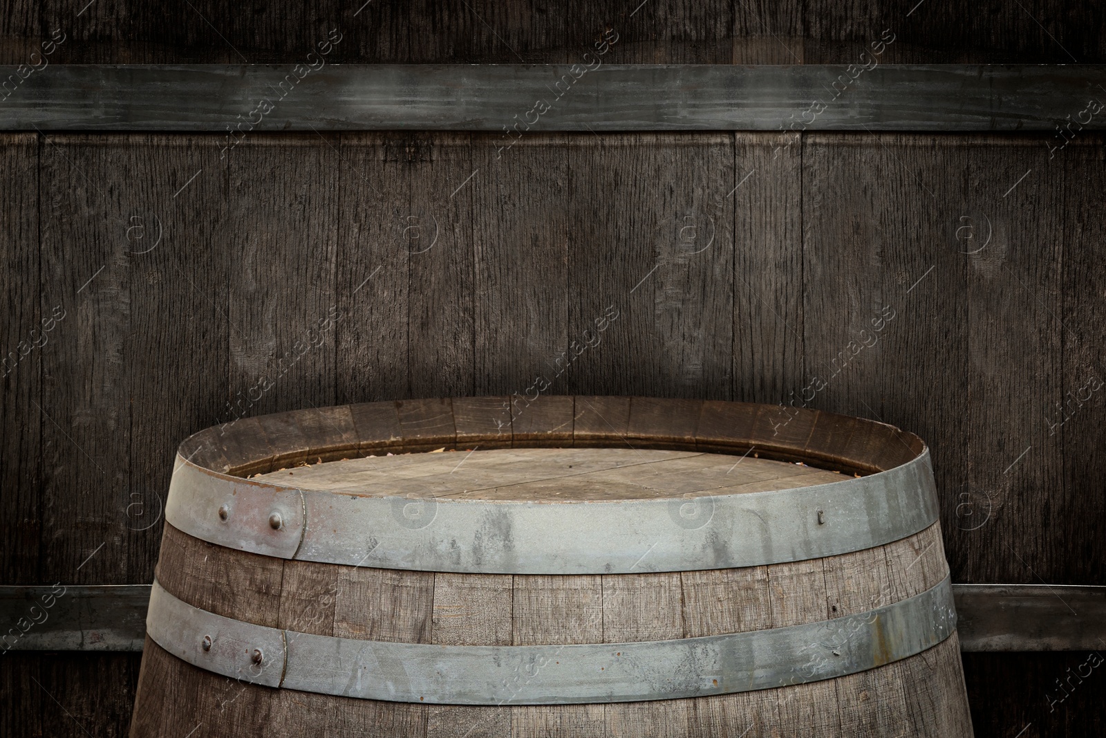 Image of One wooden barrel near textured wall, closeup