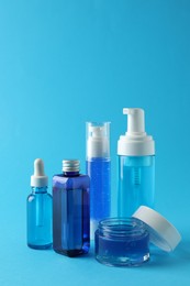 Photo of Set of luxury cosmetic products on light blue background