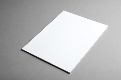 Brochure with blank cover on grey background. Mock up for design