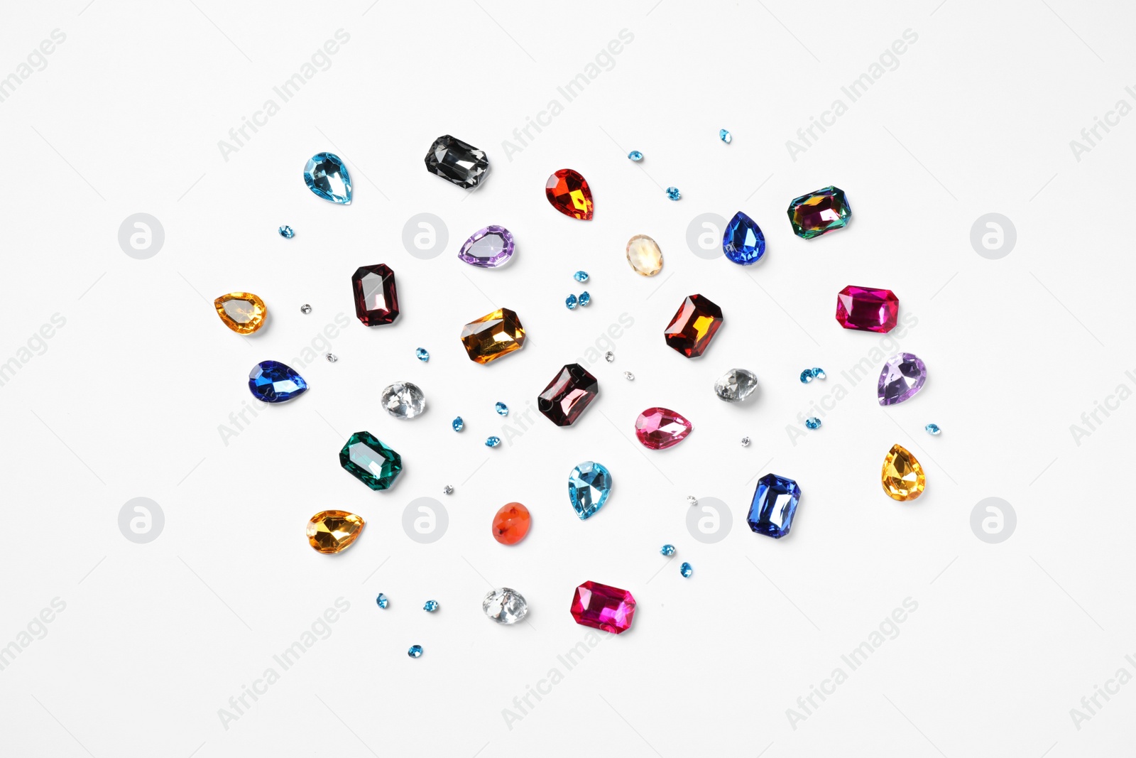 Photo of Different beautiful gemstones on white background, top view