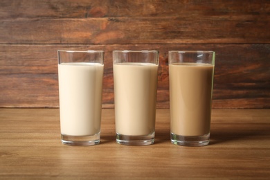 Photo of Glasses with protein shakes on wooden table