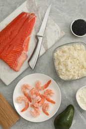 Flat lay composition with ingredients for sushi on grey marble table