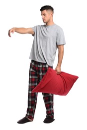 Photo of Somnambulist with red pillow on white background. Sleepwalking