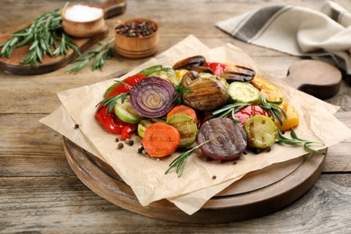 Photo of Delicious grilled vegetables with rosemary on wooden table