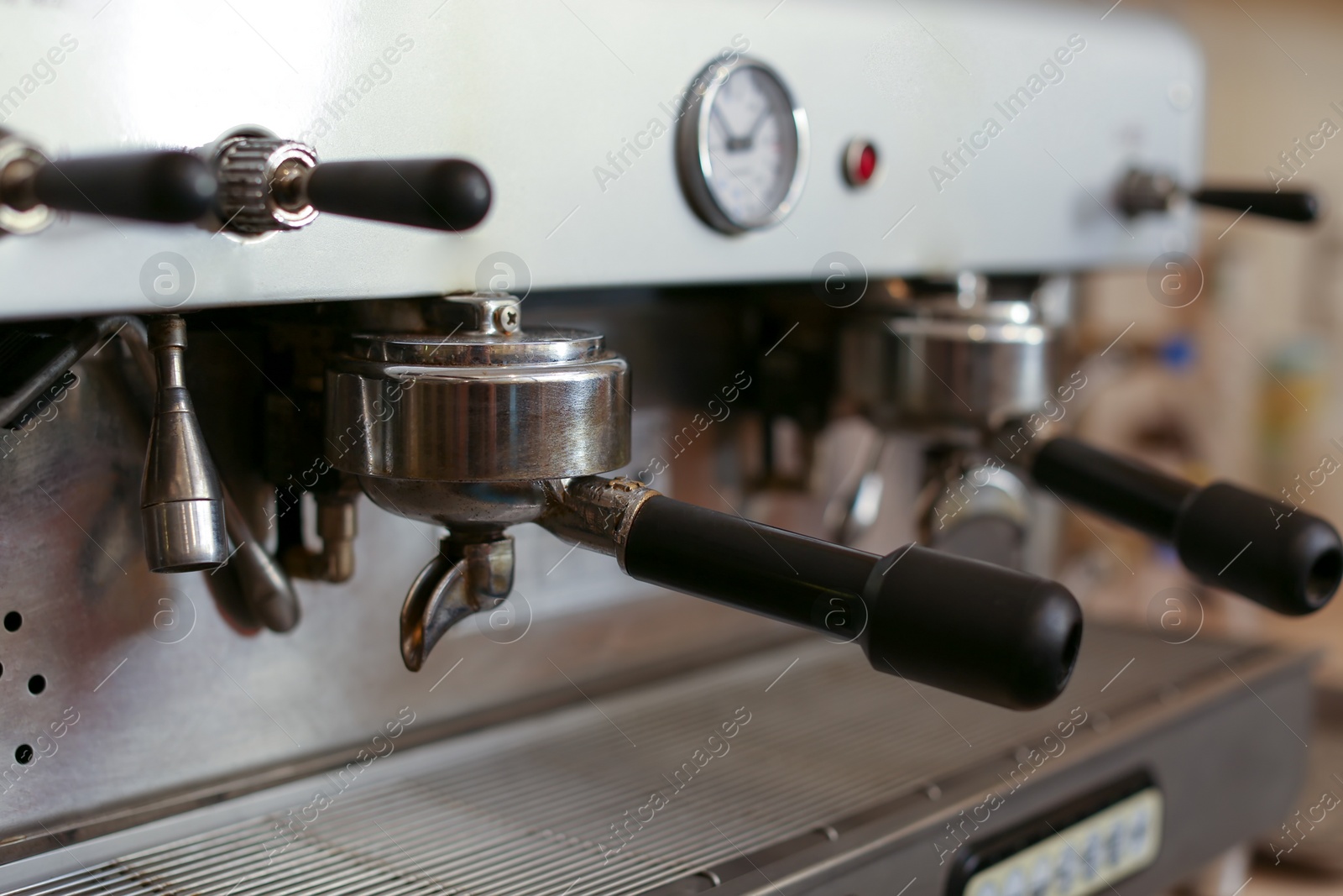 Photo of Modern electric coffee machine with portafilters, closeup