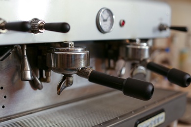 Modern electric coffee machine with portafilters, closeup