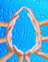Image of Women forming water drop with their hands on blue background. Ecology protection