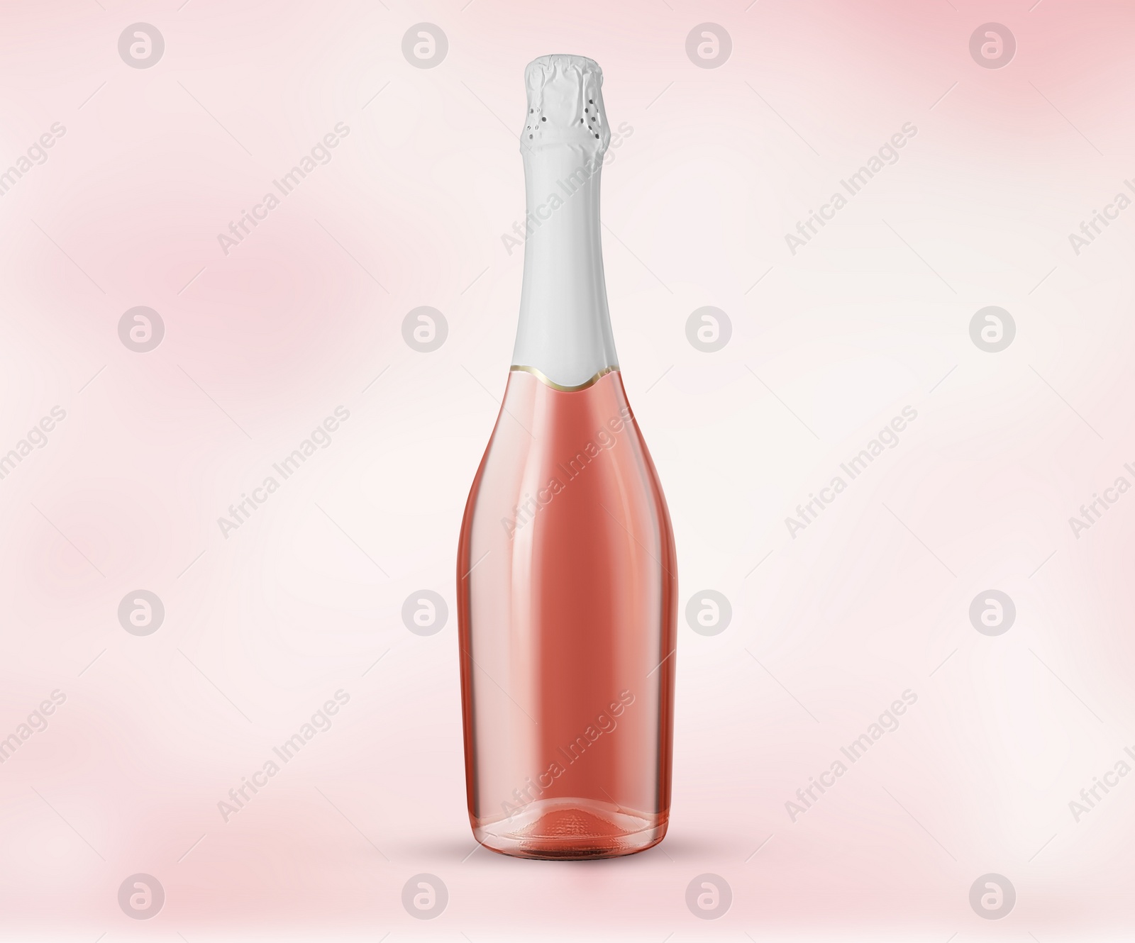 Image of Bottle of expensive sparkling rose wine on light pink background