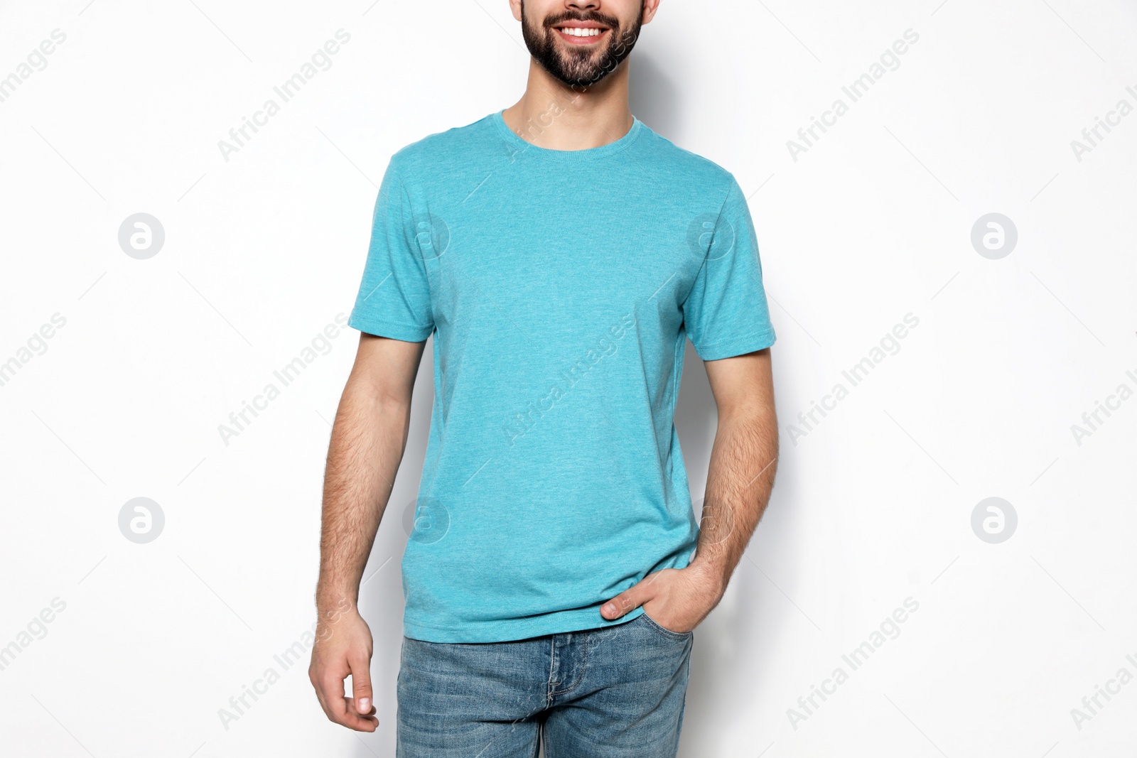 Photo of Young man in t-shirt on light background, closeup. Mock up for design