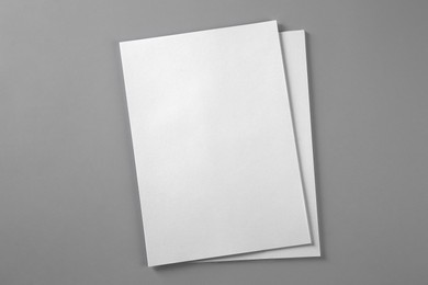 Photo of Blank brochures on grey background, top view. Mockup for design