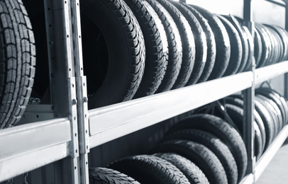Photo of Tires on rack in car service workshop