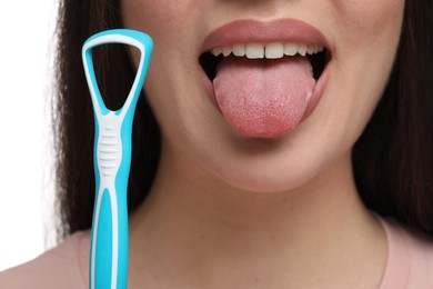 Photo of Woman with tongue cleaner on white background, closeup