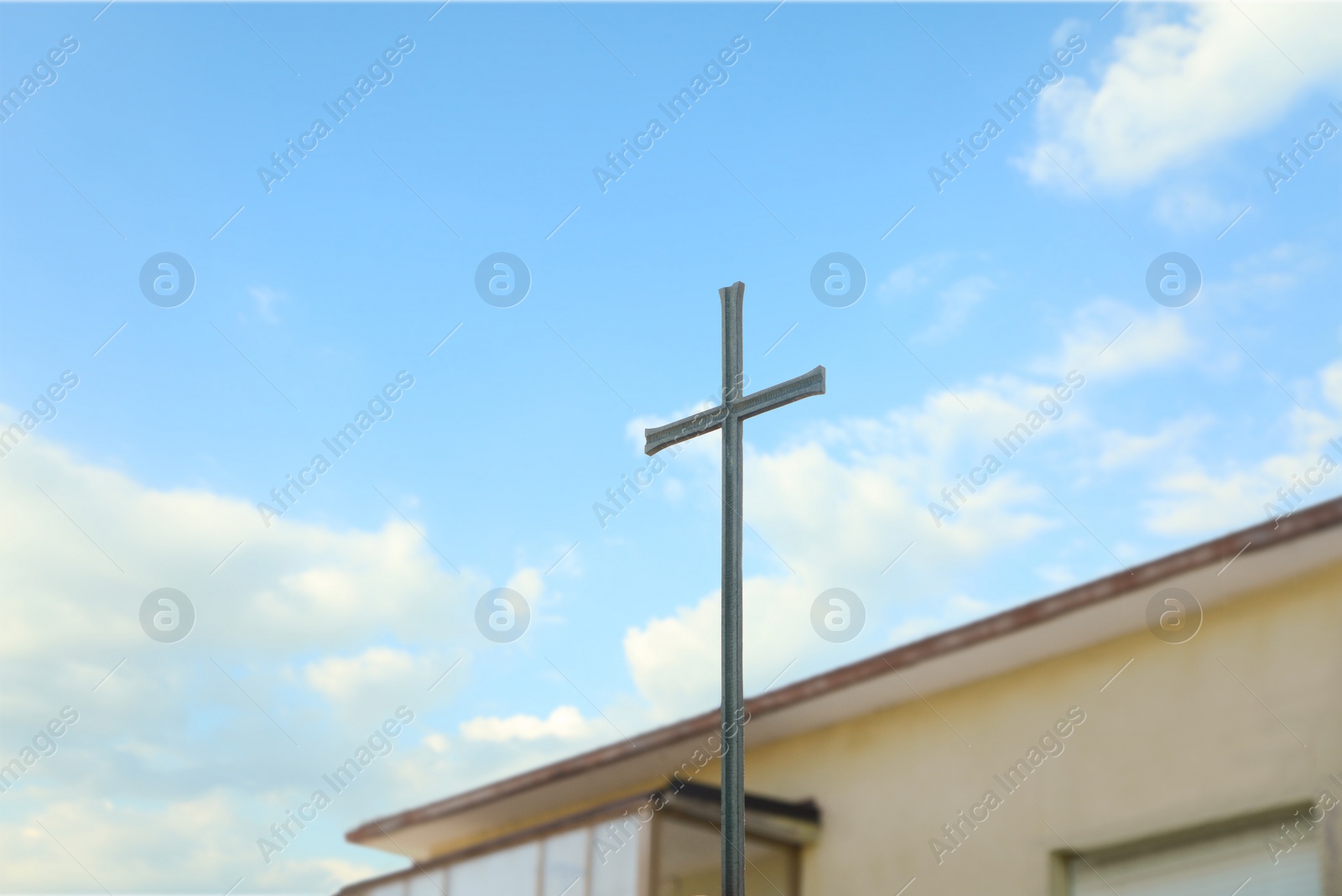 Photo of Metal Christian cross outdoors on sunny day