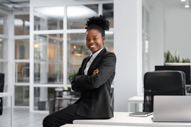 Photo of Happy woman with crossed arms in office. Lawyer, businesswoman, accountant or manager