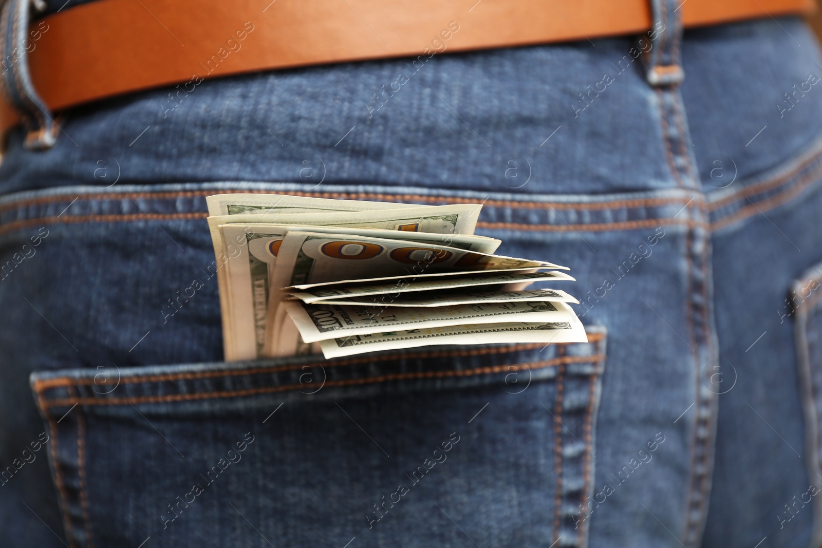 Photo of Dollar banknotes in pocket of jeans, closeup. Spending money