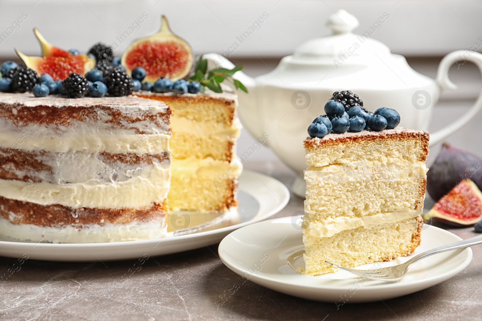 Photo of Piece of delicious homemade cake with fresh berries served on table