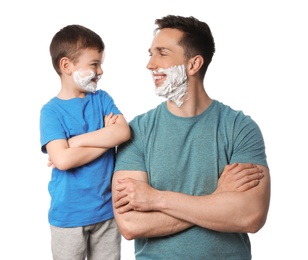 Photo of Happy dad and son with shaving foam on faces against white background
