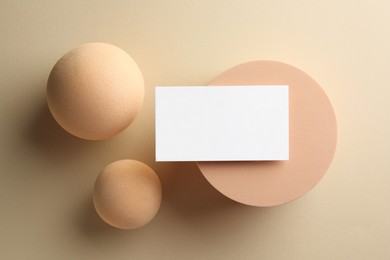 Empty business card and decorative elements on beige background, flat lay. Mockup for design