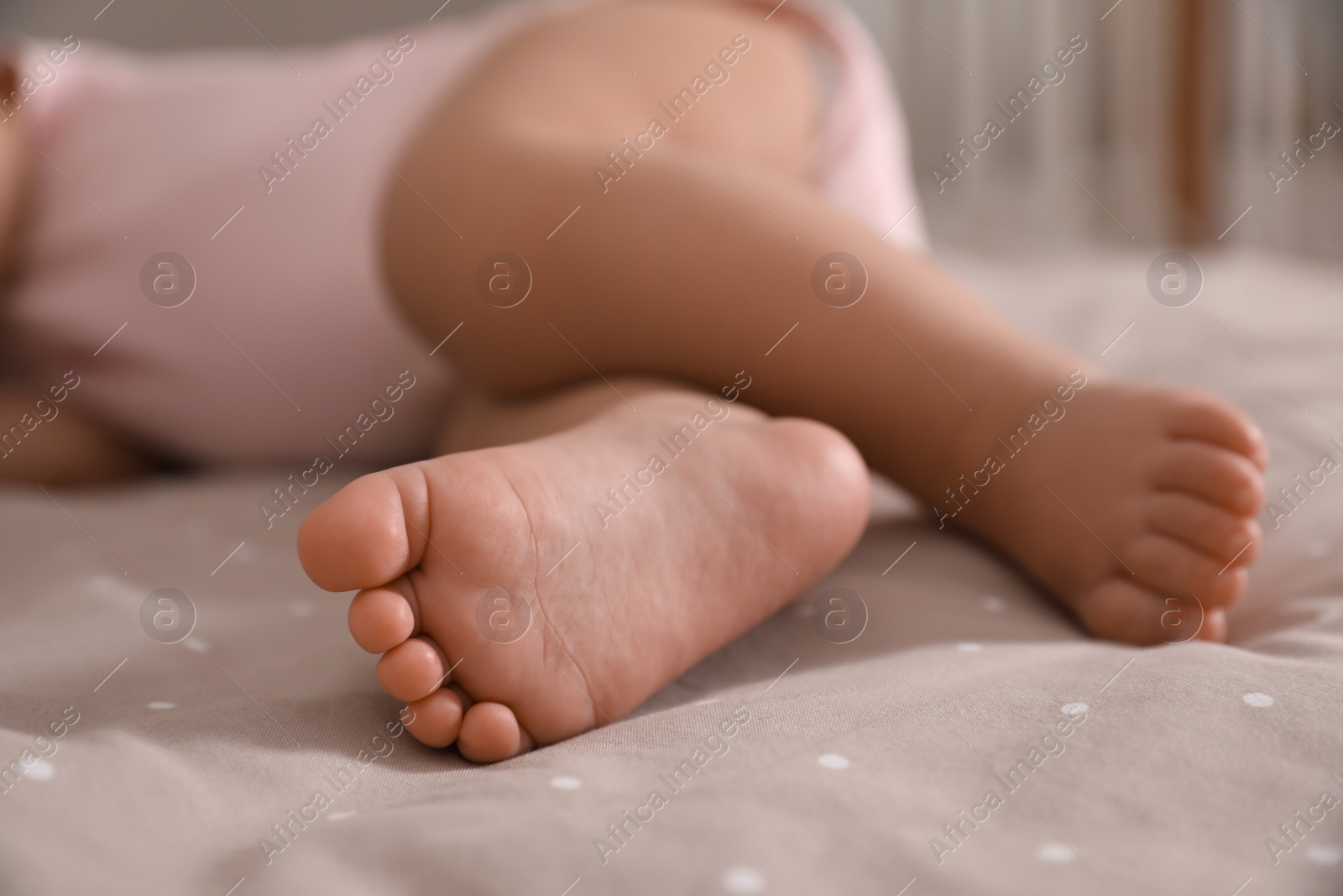 Photo of Adorable little baby sleeping on bed at home, closeup