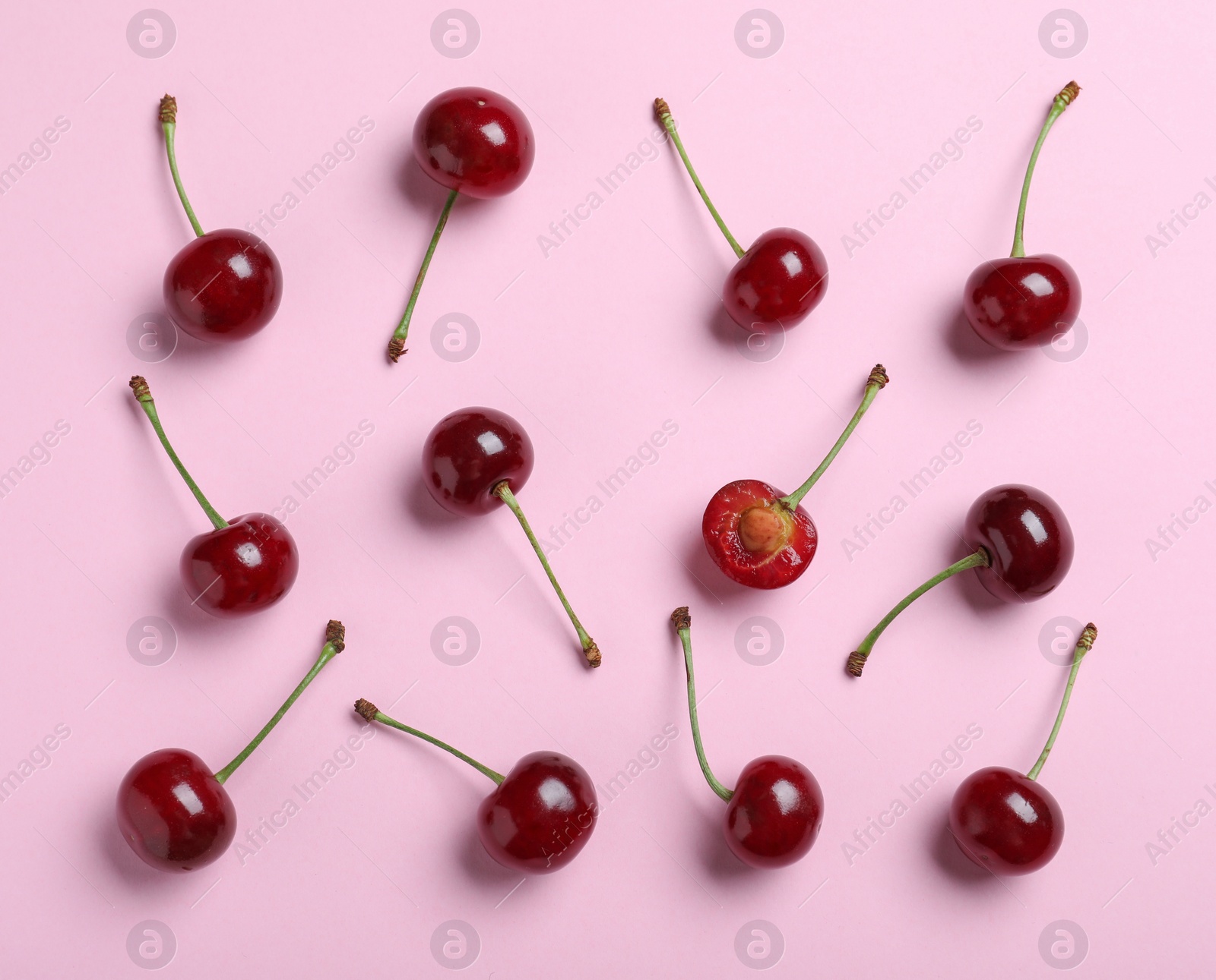 Photo of Sweet juicy cherries on pink background, flat lay