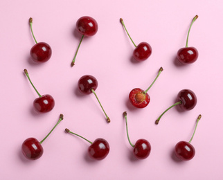 Sweet juicy cherries on pink background, flat lay