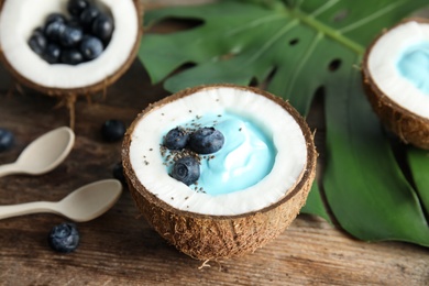 Coconut with spirulina smoothie on wooden table