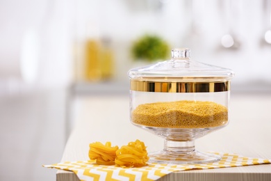 Raw pasta on wooden table in modern kitchen