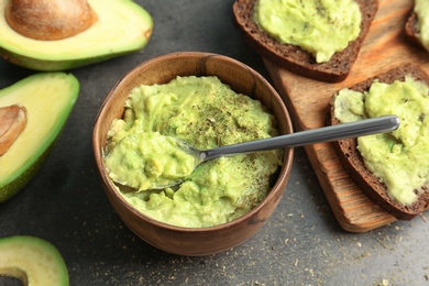 Bowl with guacamole made of avocado on table