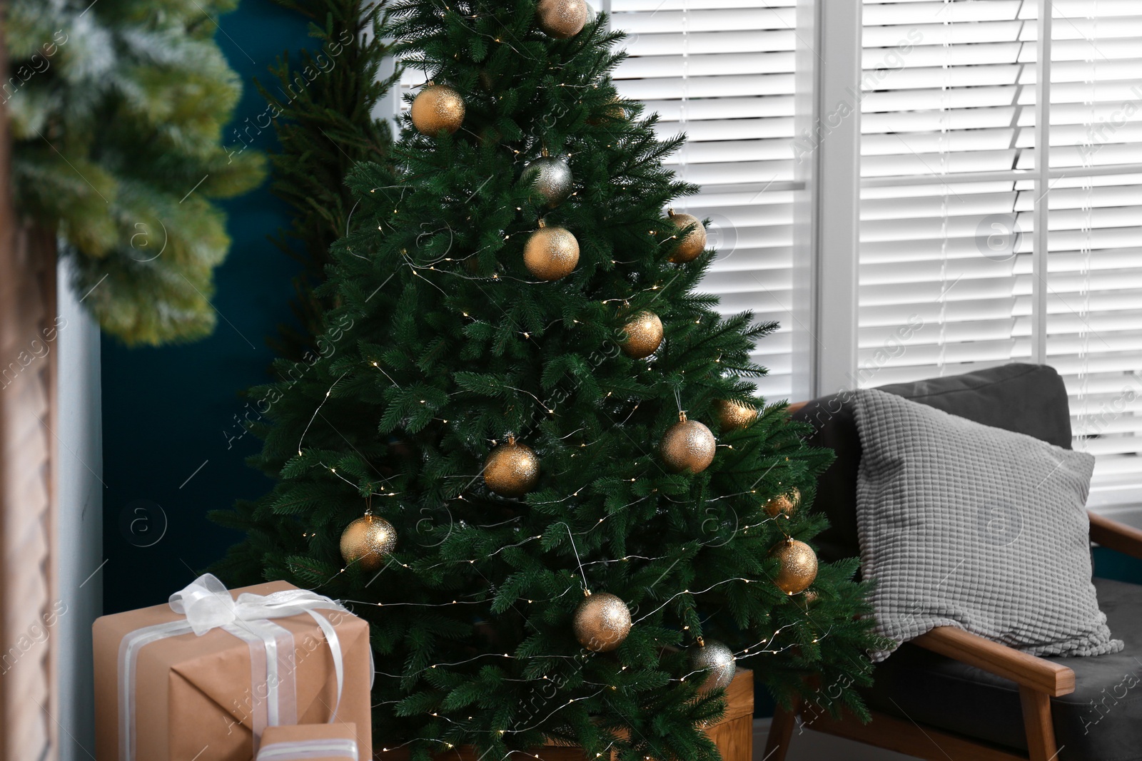 Photo of Beautiful decorated Christmas tree in living room