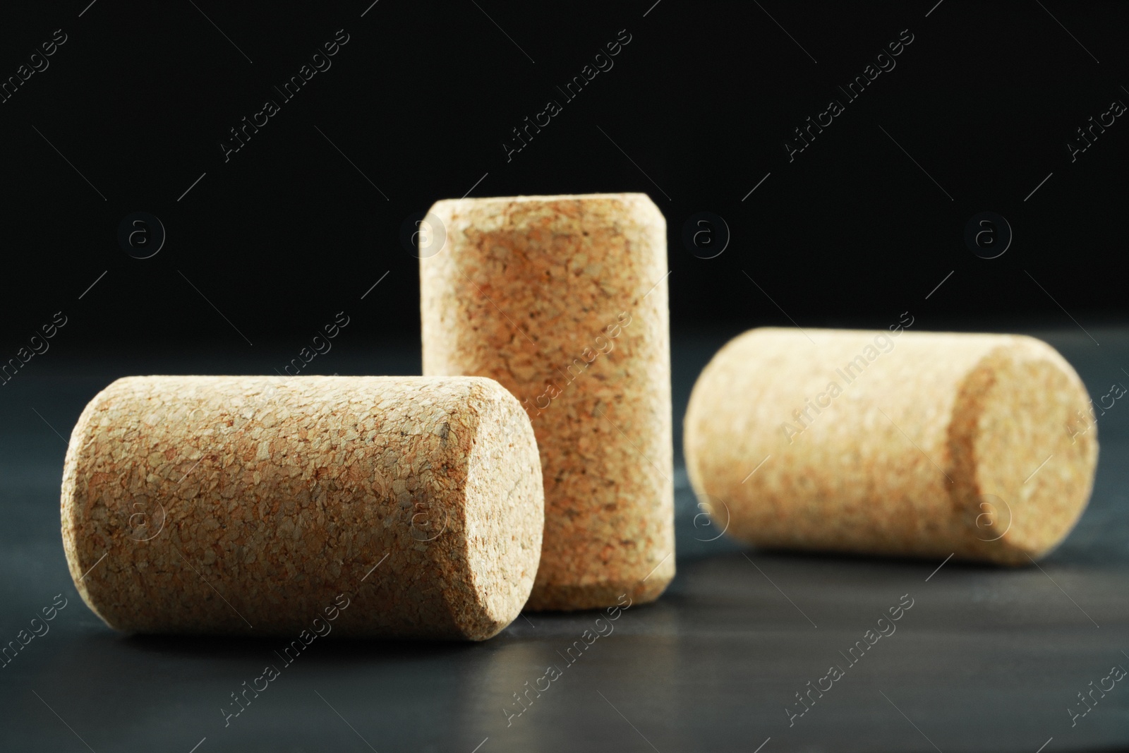 Photo of Corks of wine bottles on grey table, closeup