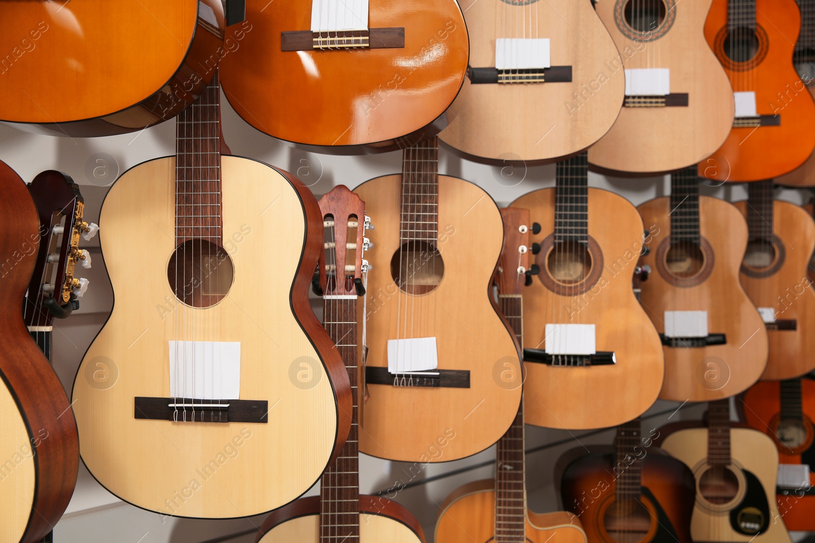 Photo of Rows of different guitars in music store