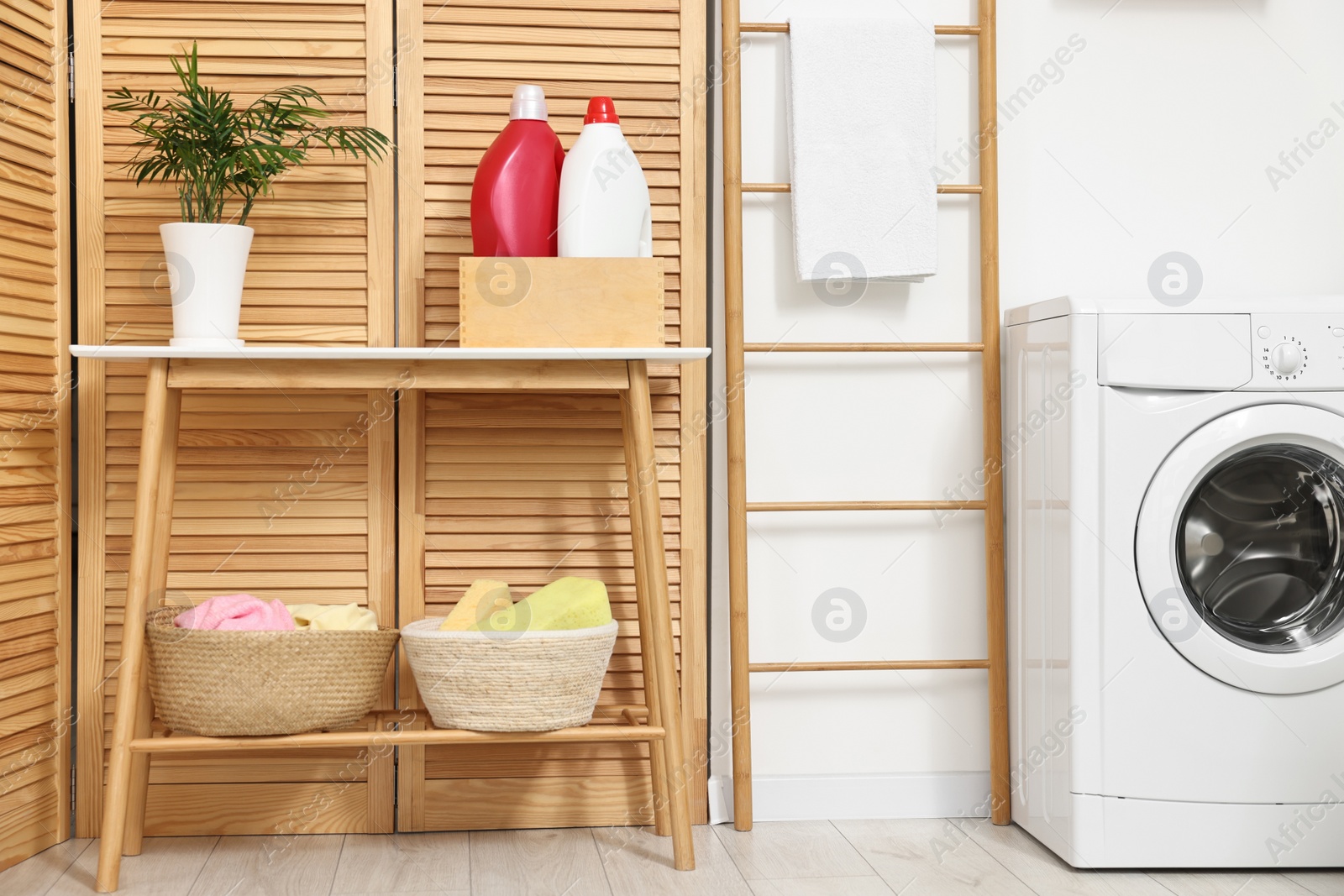 Photo of Laundry room interior with washing machine and furniture