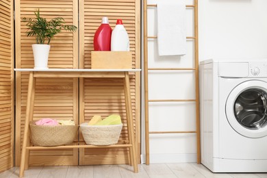 Photo of Laundry room interior with washing machine and furniture