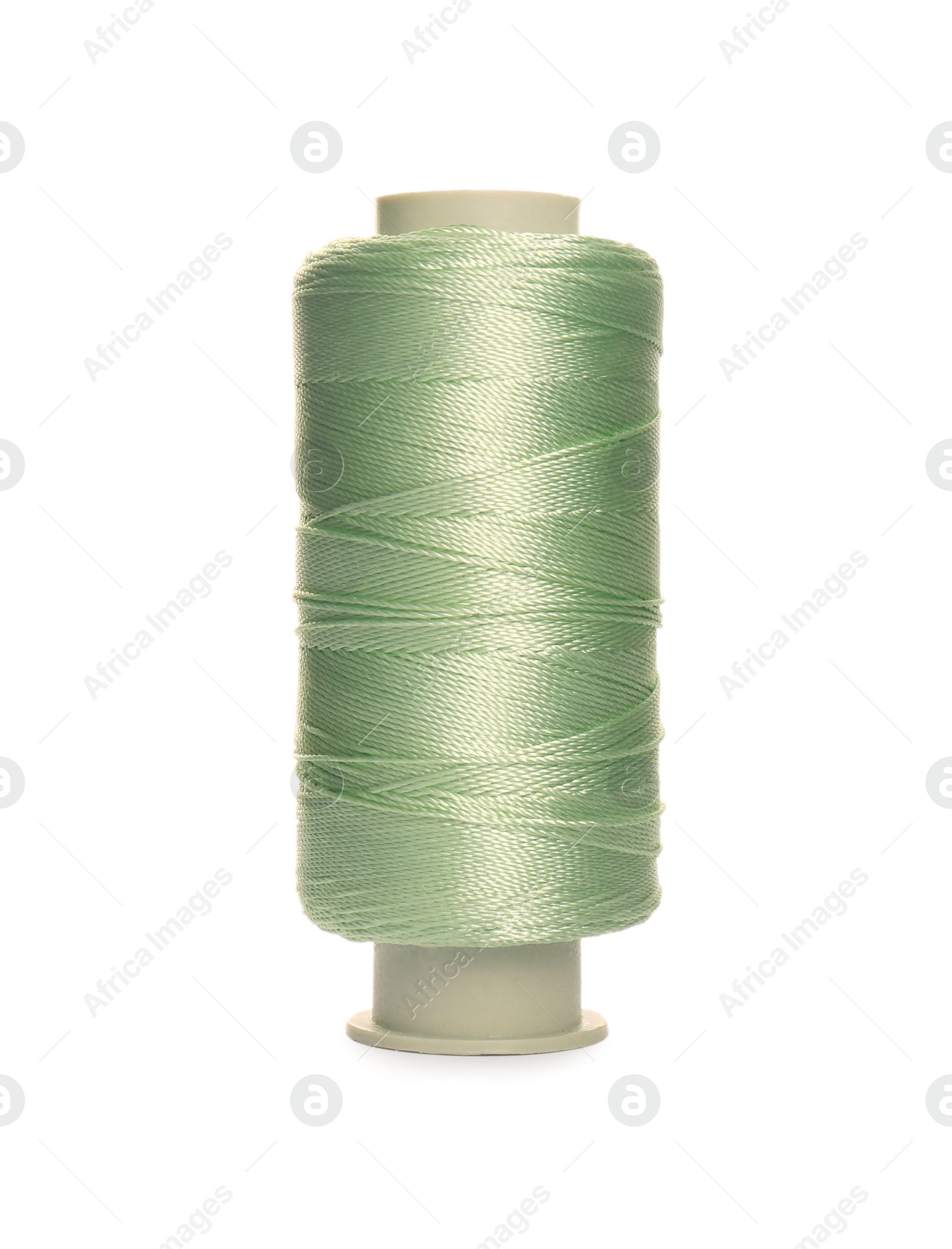 Photo of Spool of light green sewing thread isolated on white