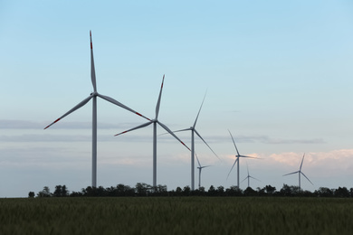 Photo of Beautiful view of landscape with wind turbines in evening. Alternative energy source