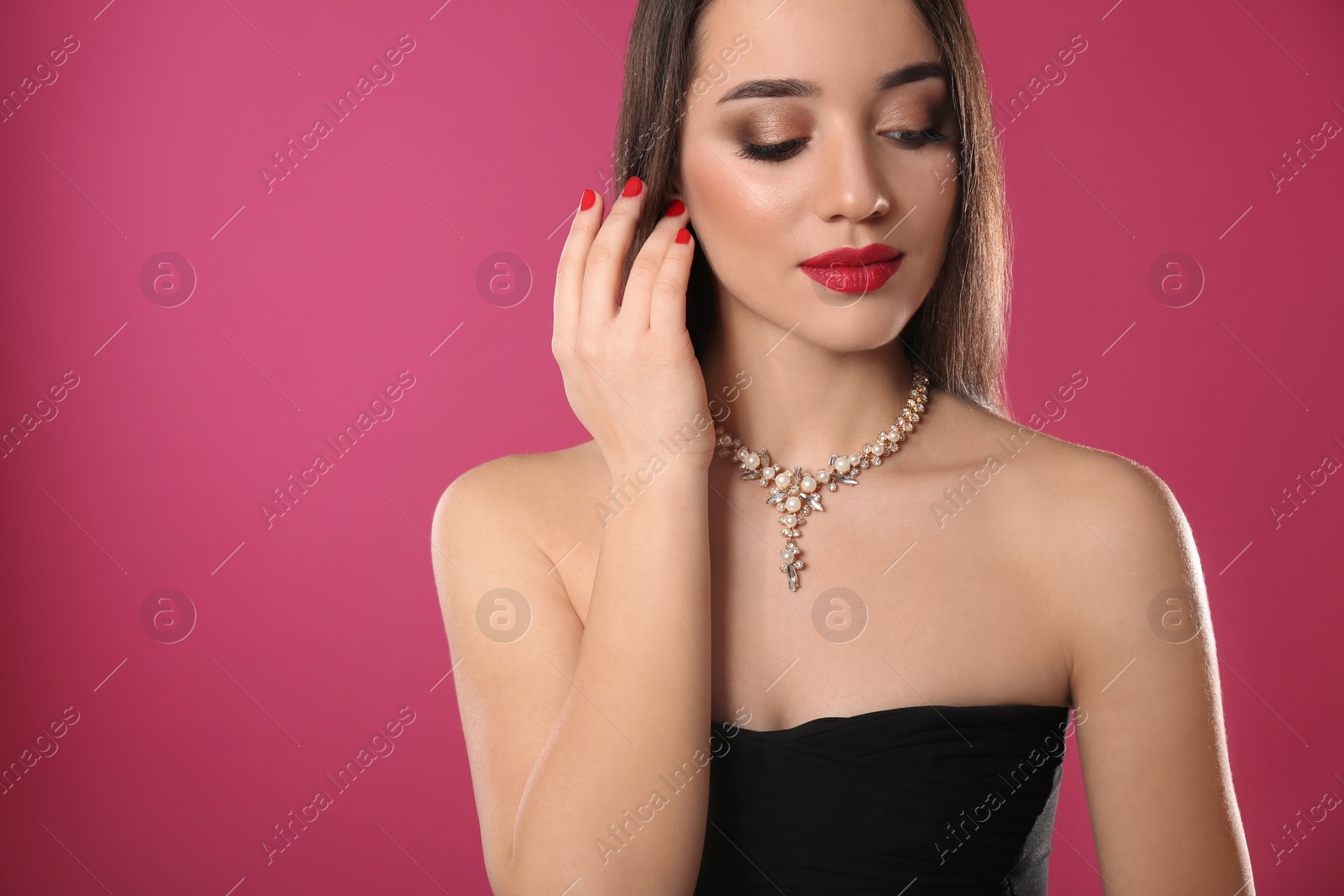 Photo of Beautiful woman with stylish jewelry on color background, space for text