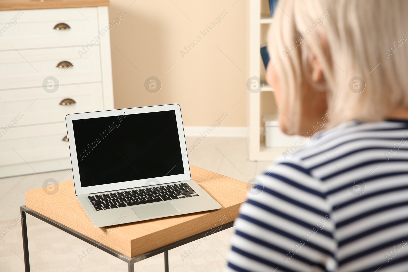 Photo of Woman using video chat on laptop at home, closeup. Space for text