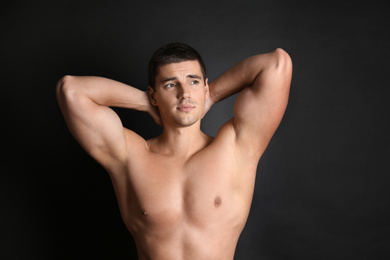 Photo of Man with sexy body on black background