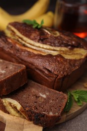 Photo of Delicious banana bread on brown table, closeup