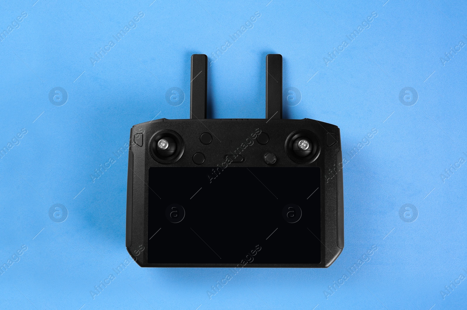 Photo of New modern drone controller on blue background, top view