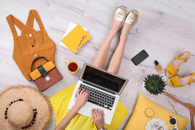 Photo of Fashion blogger with laptop sitting on floor, top view