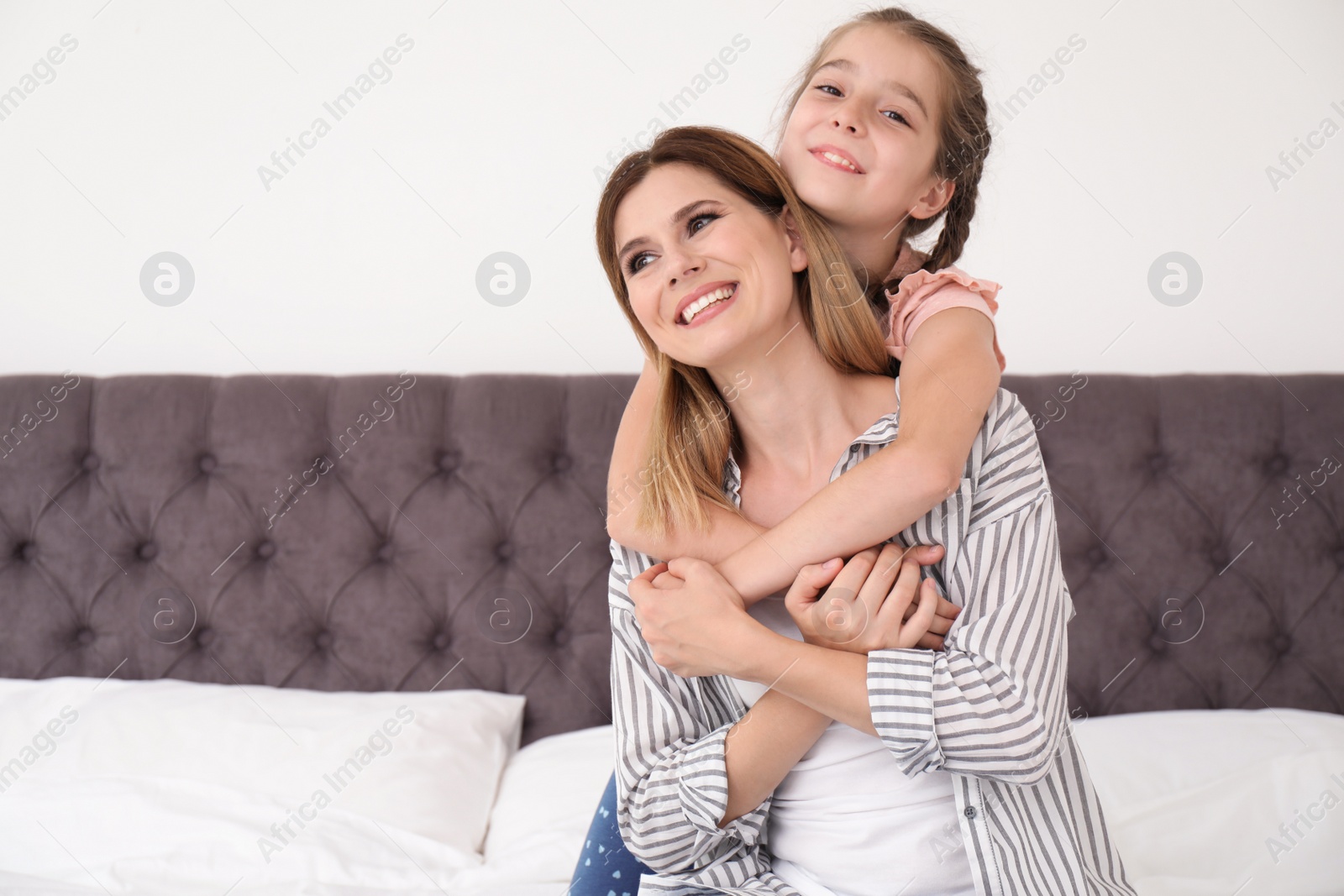 Photo of Mother with cute child in bedroom. Happy family