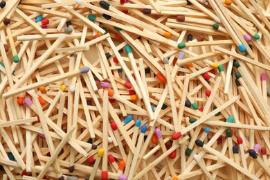 Photo of Matches with colorful heads as background, top view