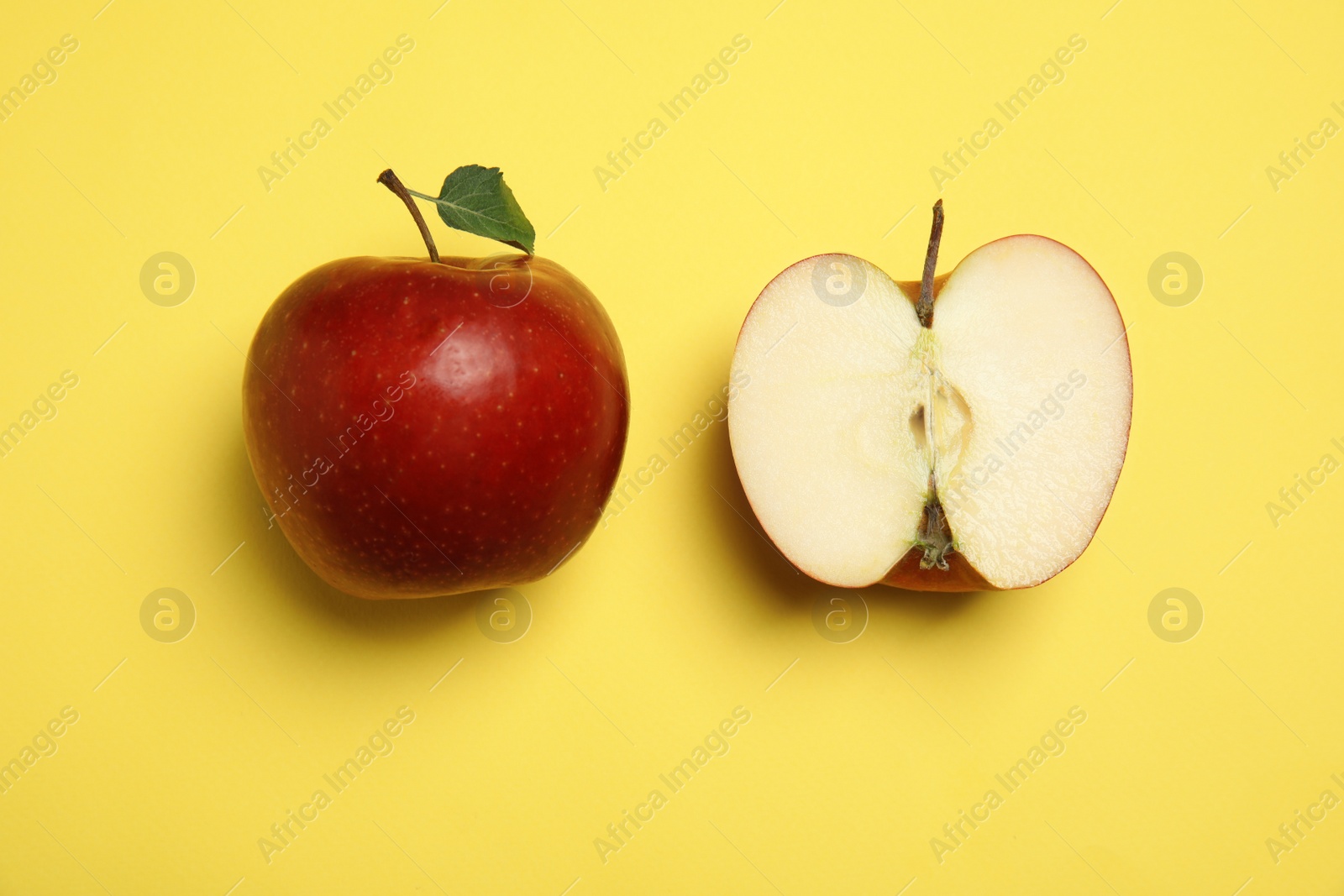 Photo of Flat lay composition with ripe juicy red apples on yellow background