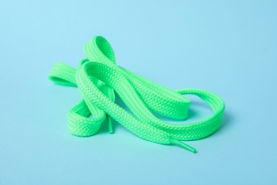 Photo of Mint shoe lace on light blue background